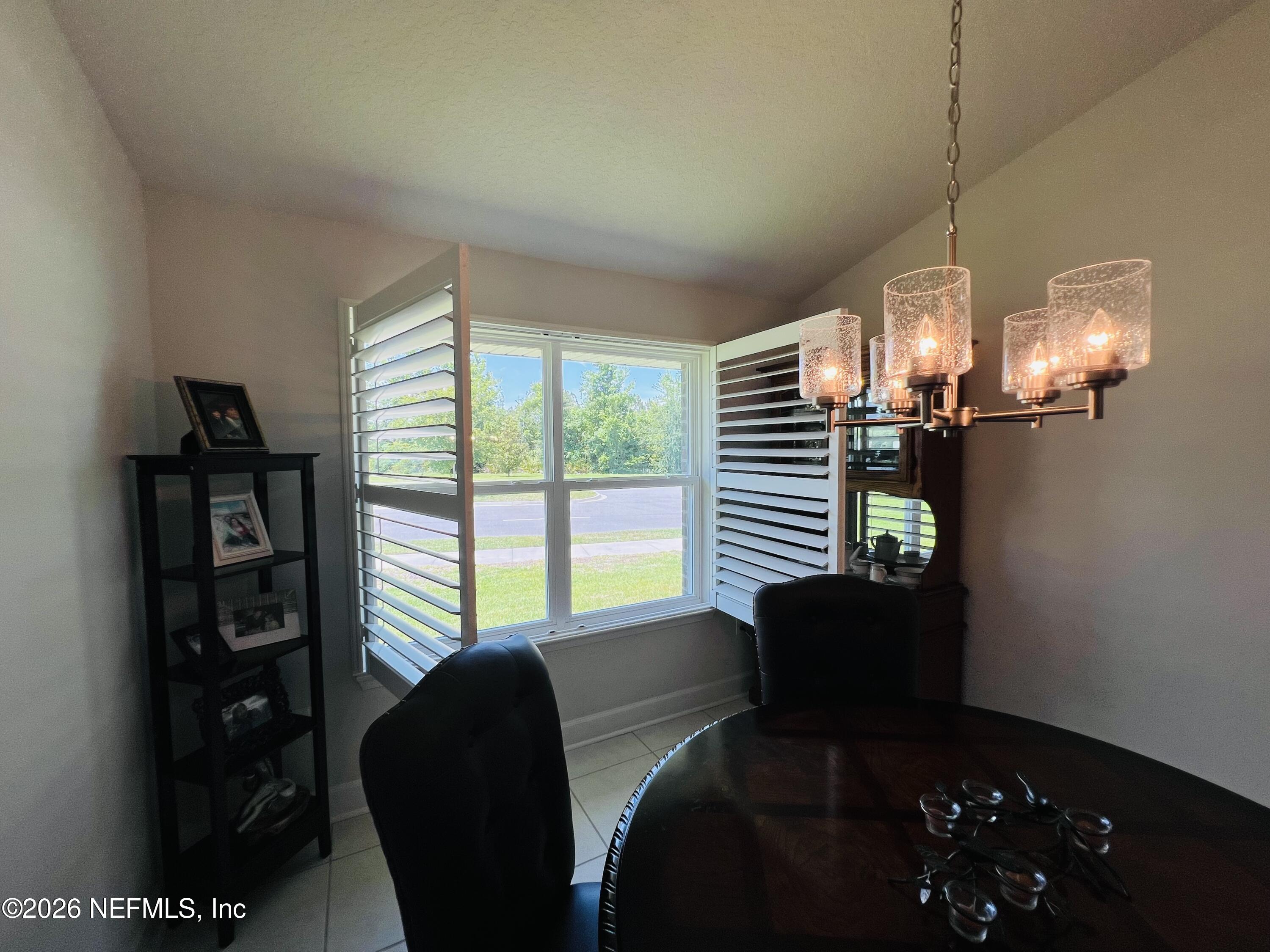 2 Rivertown Road Palm Coast, FL 32137 - Photo 29 of 80 a dining room with furniture and a chandelier