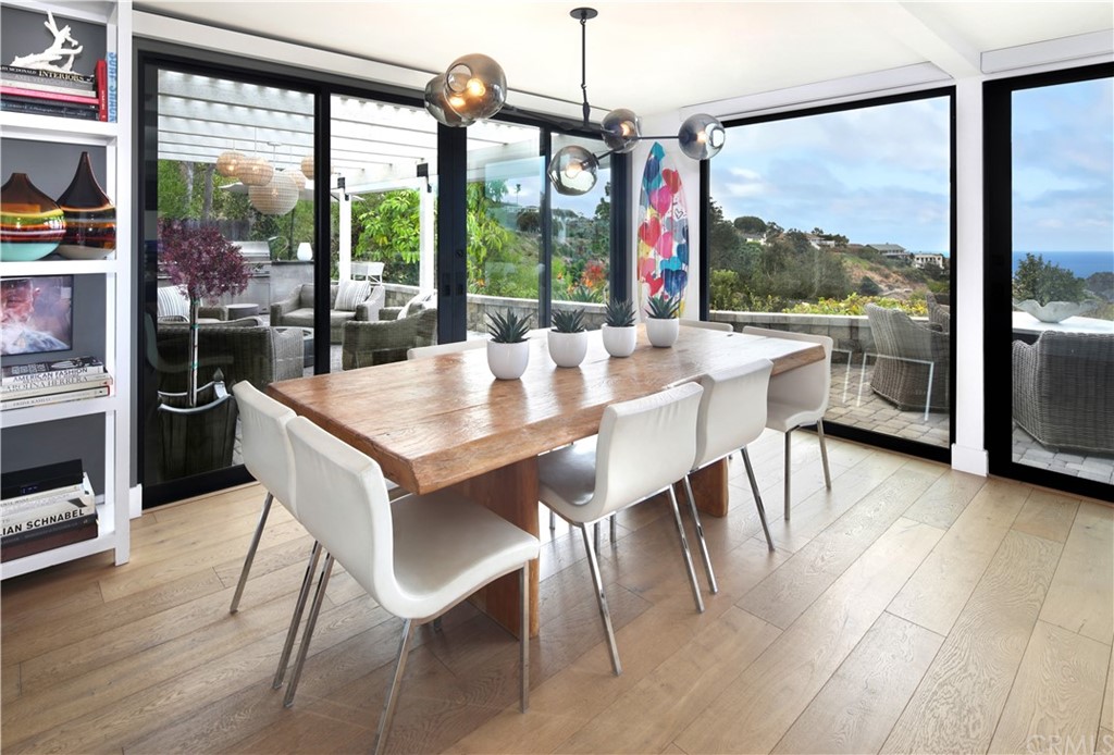 3164 Bern Drive Laguna Beach, CA 92651 - Photo 10 of 33 a view of a dining room with furniture large windows and wooden floor