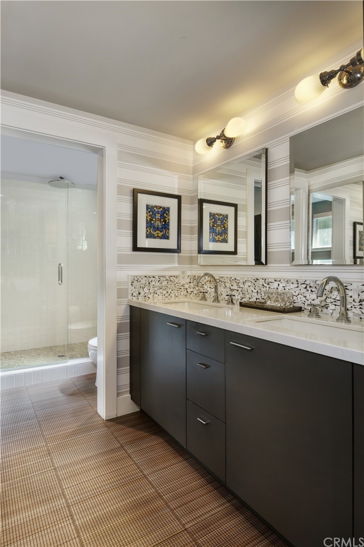 3164 Bern Drive Laguna Beach, CA 92651 - Photo 14 of 33 a spacious bathroom with a granite countertop sink and a mirror