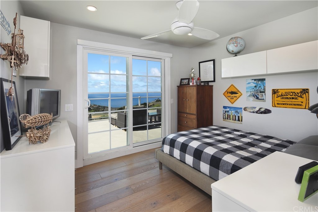 3164 Bern Drive Laguna Beach, CA 92651 - Photo 19 of 33 a bedroom with a bed and a table with wooden floor