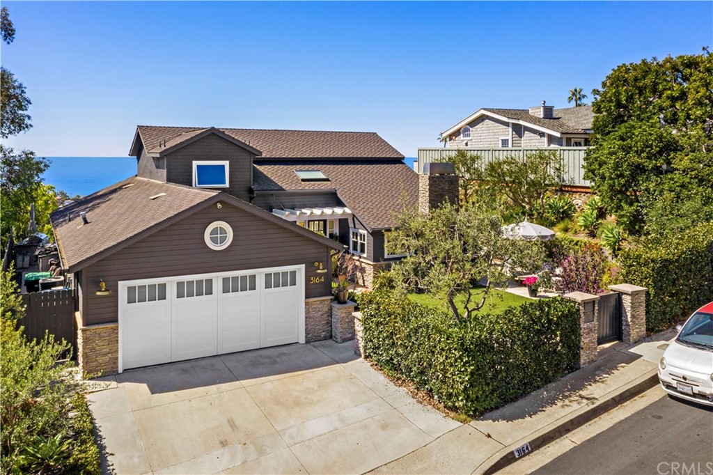 3164 Bern Drive Laguna Beach, CA 92651 - Photo 31 of 33 a front view of a house with a yard and garage