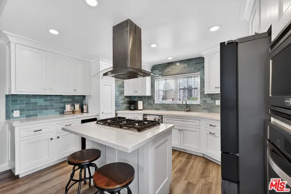 a kitchen with stainless steel appliances a sink stove and refrigerator