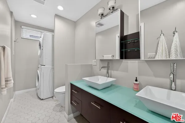 a kitchen with stainless steel appliances cabinets a sink and a counter top space