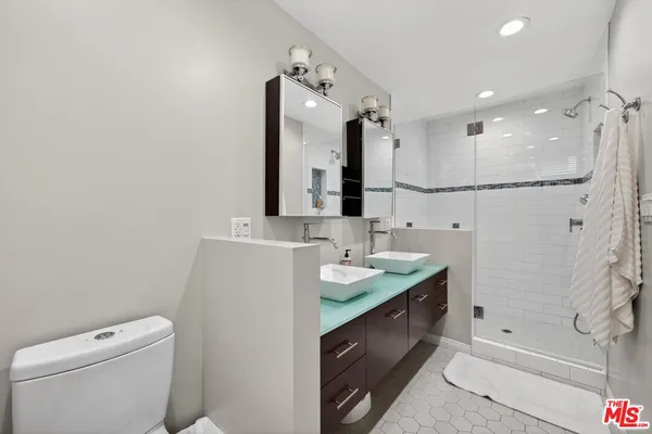 a bathroom with a double vanity sink mirror and toilet