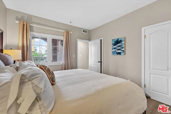 a bedroom with a large bed and a window