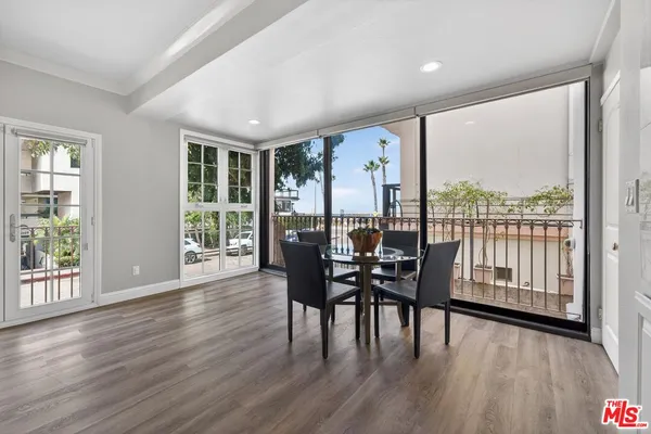 a dining room with furniture window and wooden floor