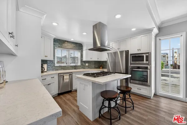 a kitchen with stainless steel appliances granite countertop a stove oven and a refrigerator