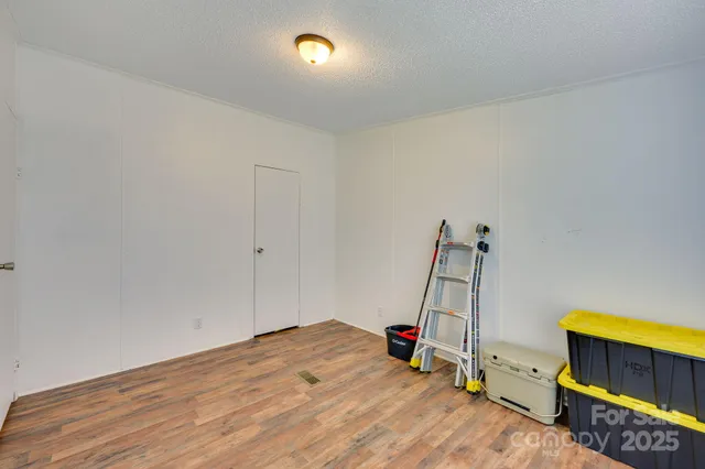 a view of an empty room and wooden floor