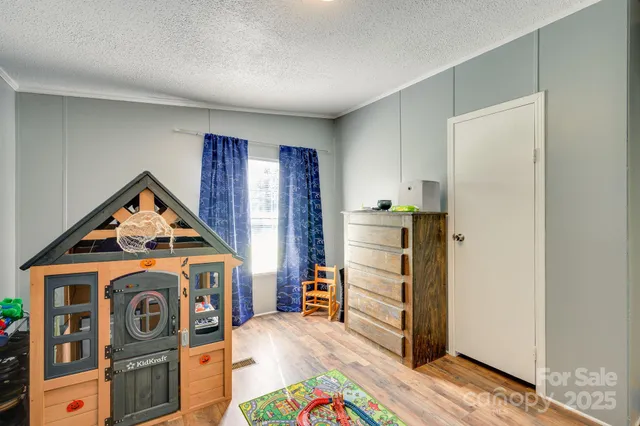 a view of an empty room with furniture and closet