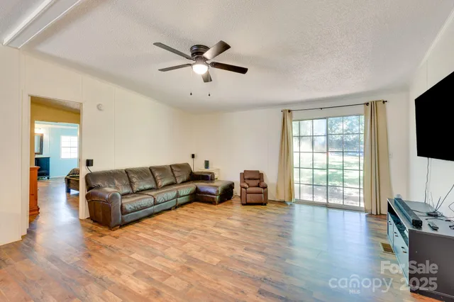 a living room with furniture window and wooden floor