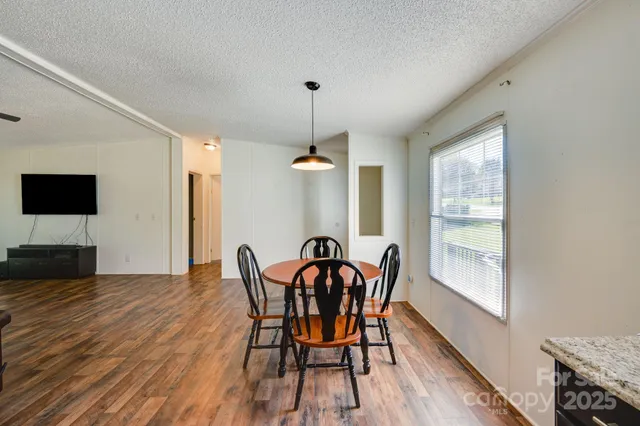 a dining room with furniture and window