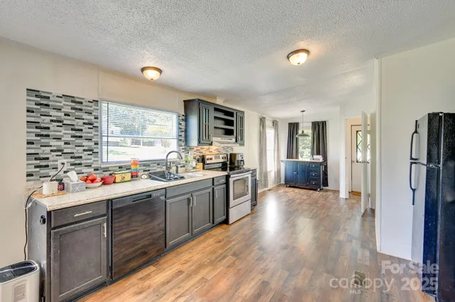 a kitchen with sink cabinets and wooden floor