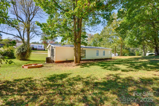 a backyard of a house with a garden and tree