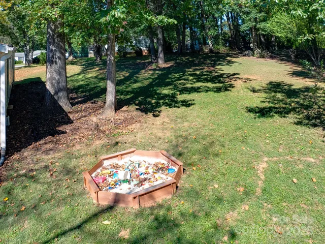 a view of a backyard with large trees