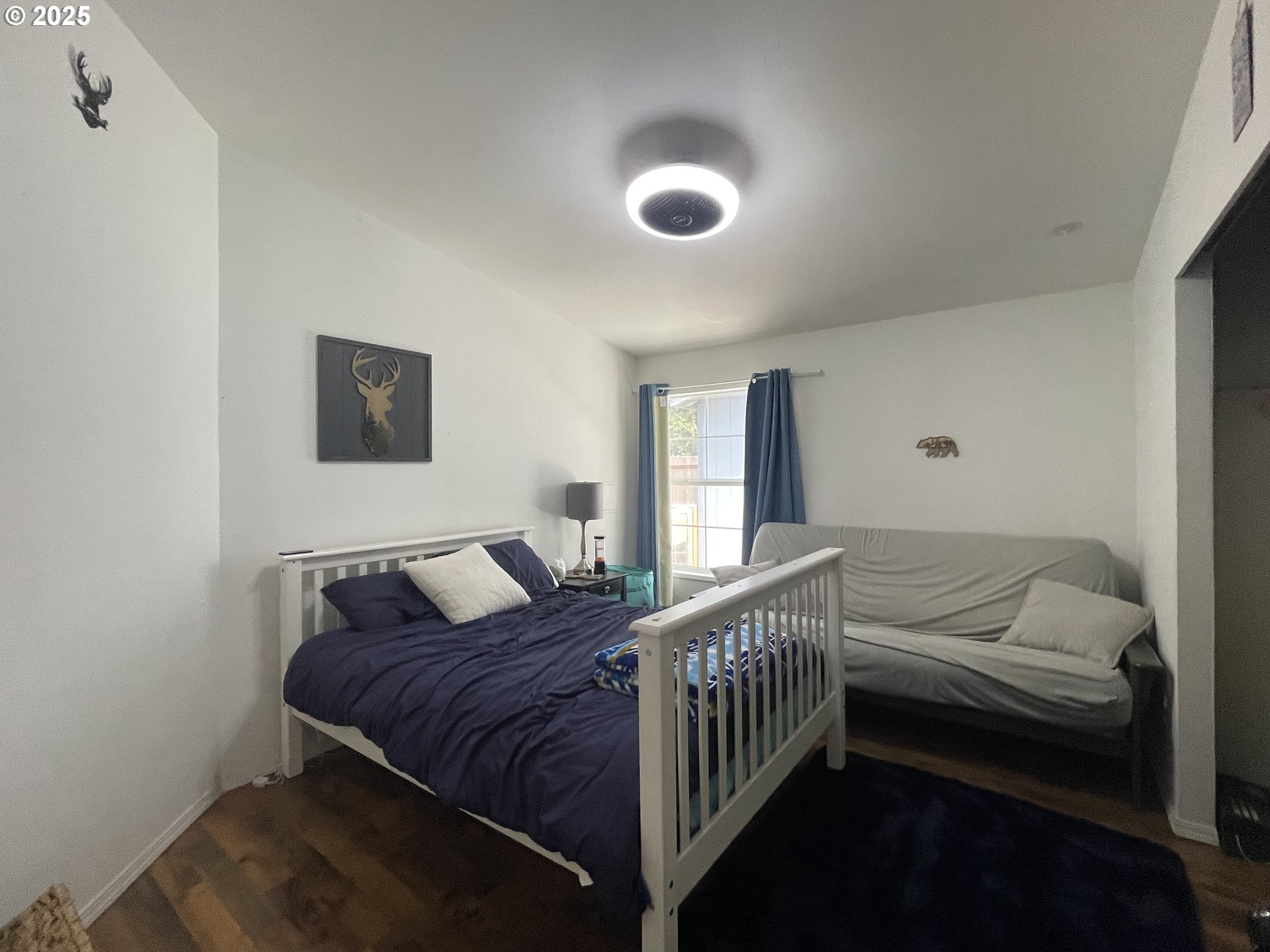 56129 Tom Smith Road Bandon, OR 97411 - Photo 12 of 27 a bedroom with a bed and a window