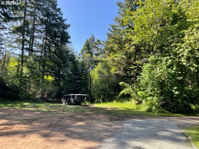 56129 Tom Smith Road Bandon, OR 97411 - Photo 16 of 27 a front view of a house with a yard