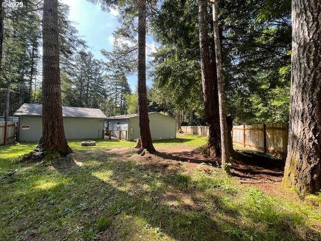 56129 Tom Smith Road Bandon, OR 97411 - Photo 22 of 27 a view of a backyard with a tree