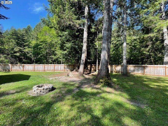 56129 Tom Smith Road Bandon, OR 97411 - Photo 23 of 27 a view of a backyard with large trees