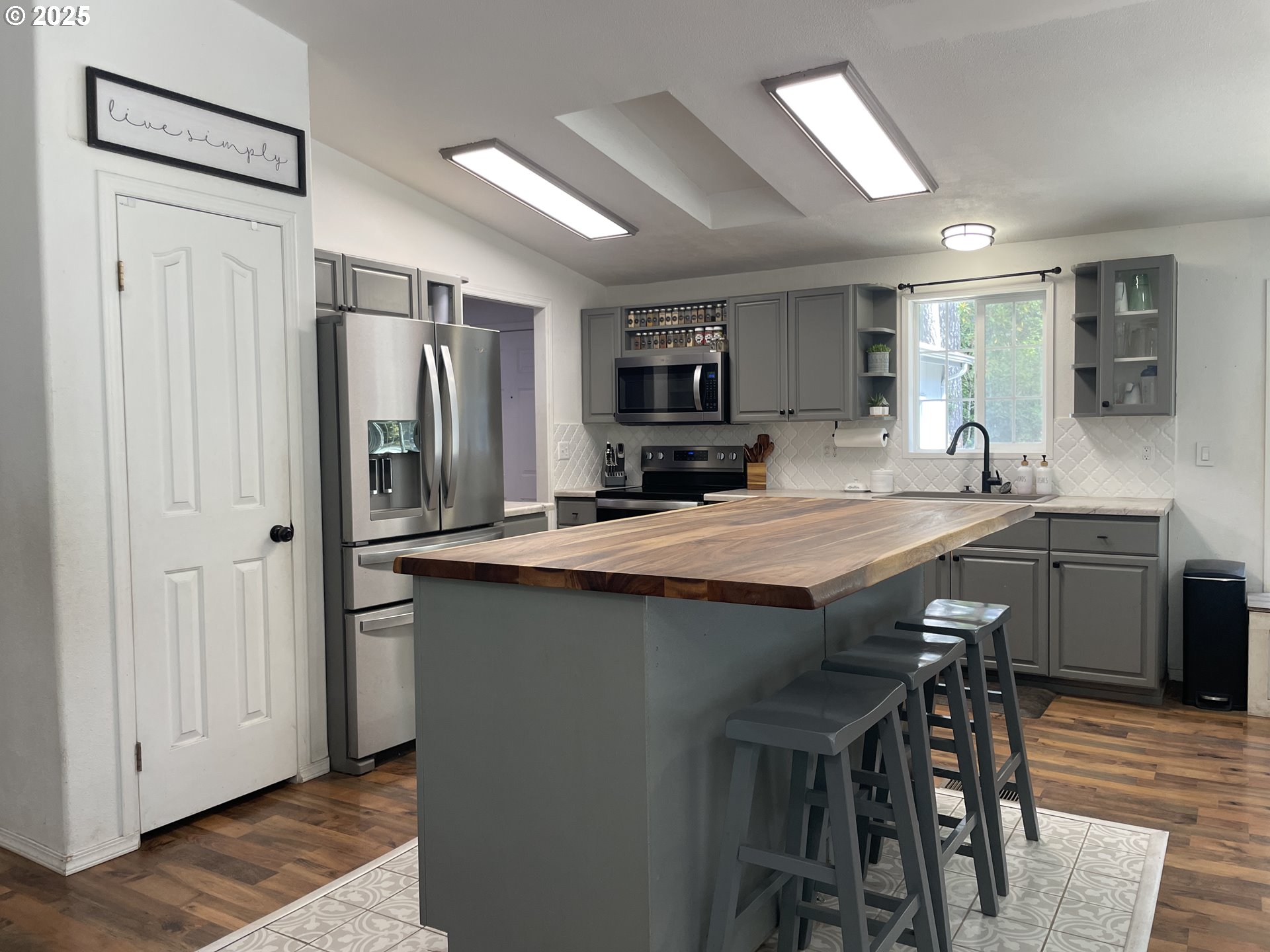56129 Tom Smith Road Bandon, OR 97411 - Photo 24 of 27 a kitchen with kitchen island a large counter top space appliances and cabinets