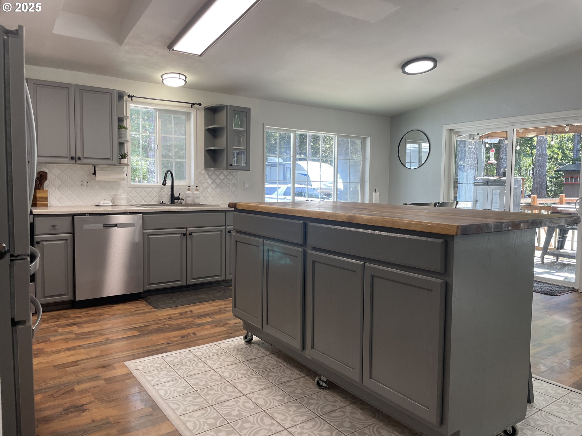 56129 Tom Smith Road Bandon, OR 97411 - Photo 25 of 27 a kitchen with center island and sink