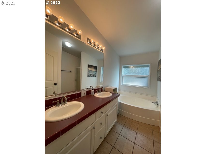 56129 Tom Smith Road Bandon, OR 97411 - Photo 9 of 27 a bath room with a sink and a mirror
