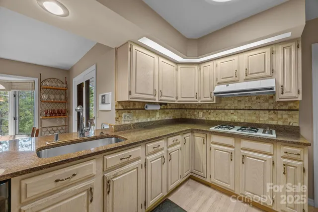 a view of workspace with wooden floor cabinet and windows