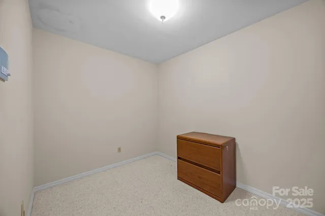 a bedroom with a bed and a night stand