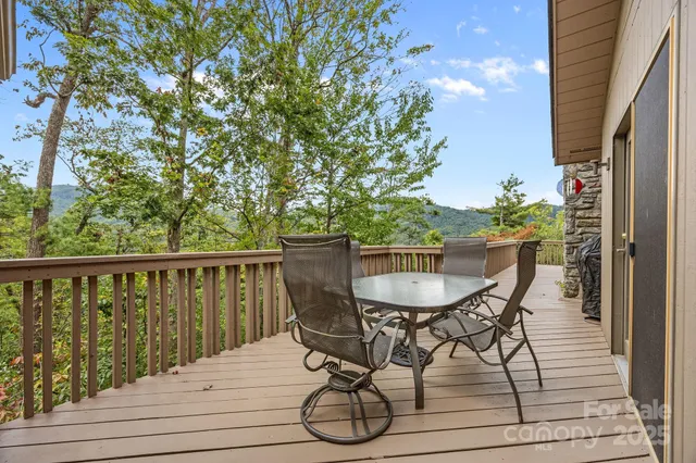 a view of a lush green forest with trees and some houses