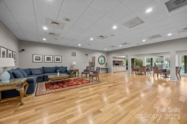 a living room with furniture a fireplace and a book shelf