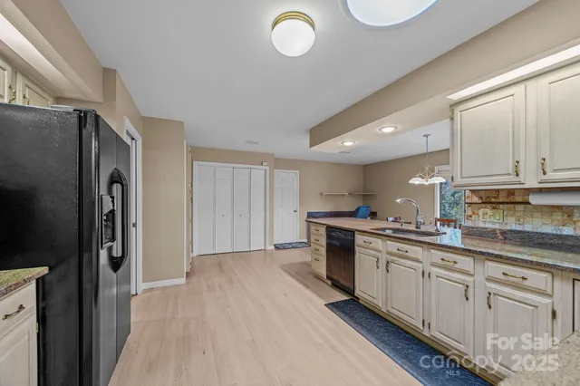 a kitchen with stainless steel appliances a refrigerator and cabinets