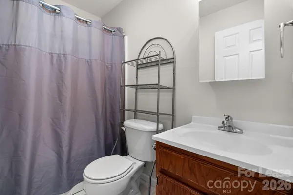 a bathroom with a sink a toilet and a shower