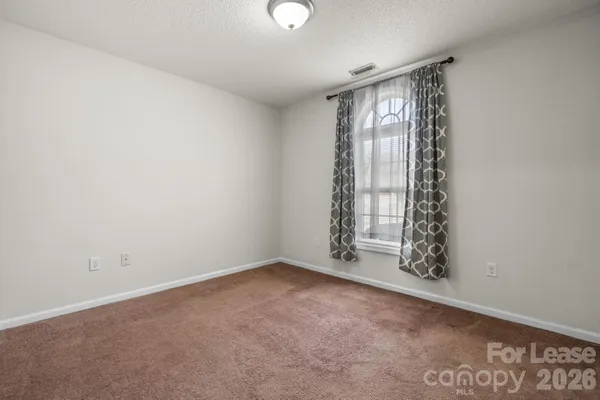 an empty room with windows and entrance