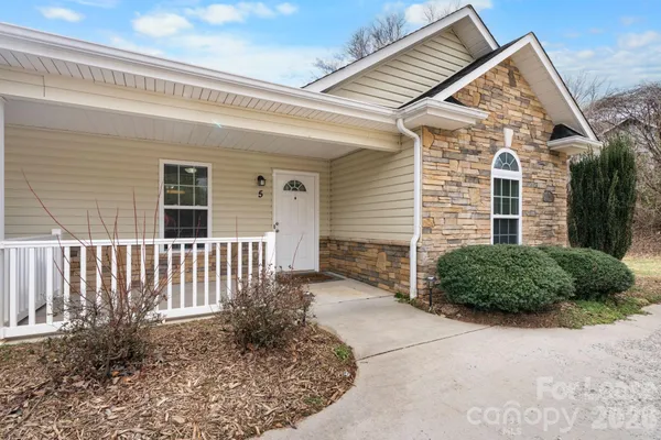 a view of a house with a small yard and plants