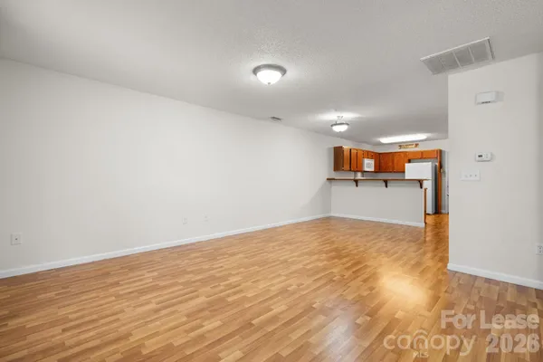 a view of a kitchen with a sink and a refrigerator