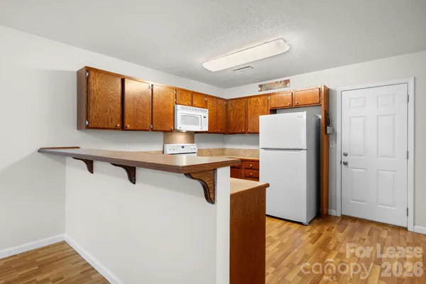 a kitchen with appliances a sink and a refrigerator