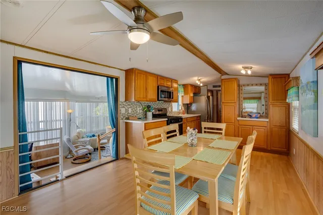 a living room with furniture a flat screen tv and a window