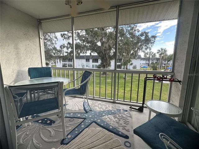 a living room with a floor to ceiling window and a table