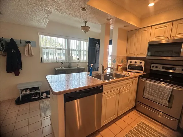 a kitchen with sink cabinets and window