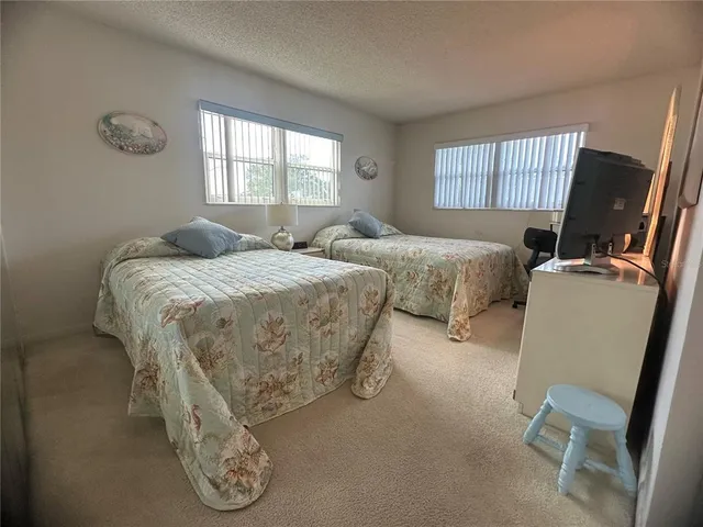 a bedroom with double bed and a window