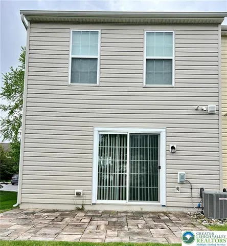 a view of a house with a small backyard