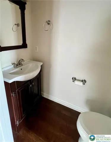 a bathroom with a sink a toilet and mirror