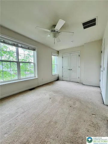 a view of a livingroom with an empty space and a window