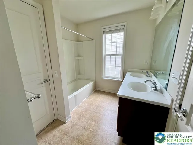 a bathroom with a sink toilet and tub