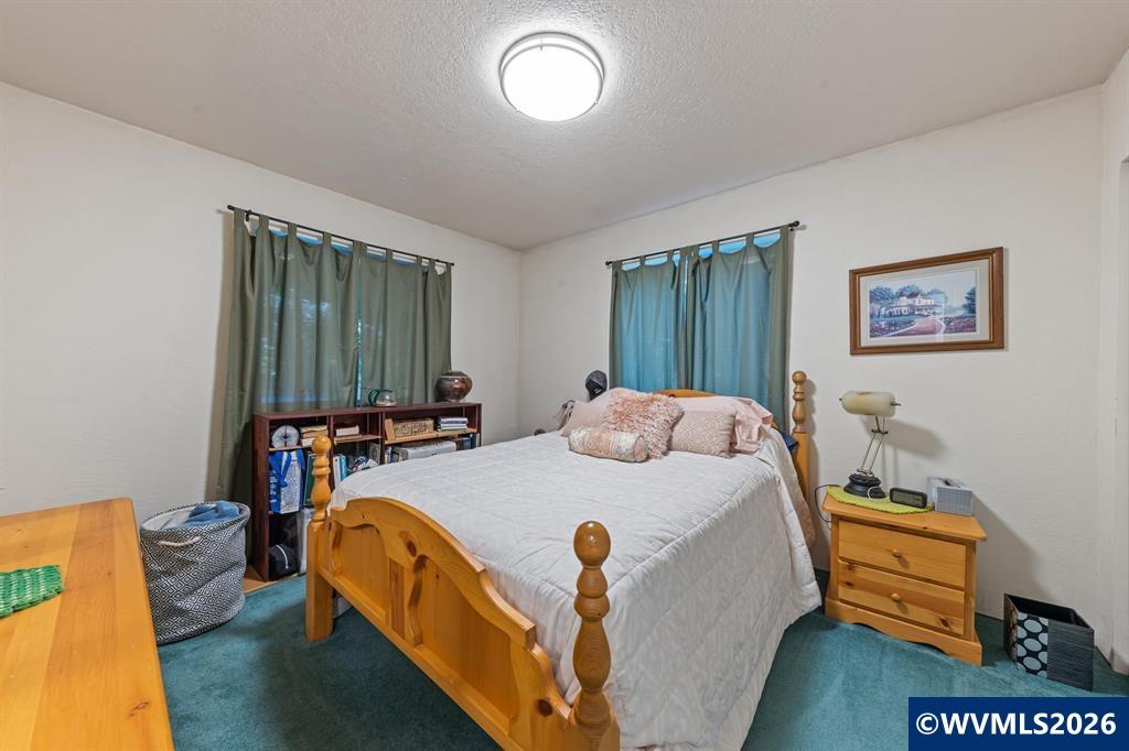 6100 Teal Creek Road Dallas, OR 97338 - Photo 20 of 41 a bed sitting in a bedroom next to a window
