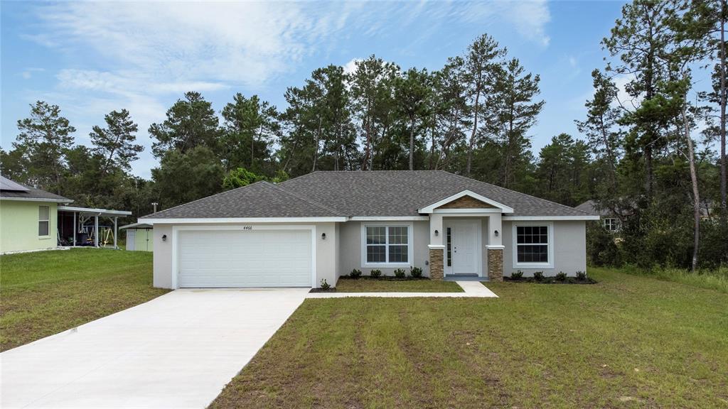 4466 Southwest 170th Street Road Ocala, FL 34473 - Photo 1 of 1 a house with trees in the background