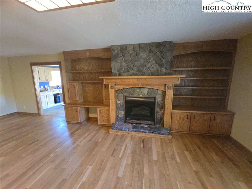 709 Deep Ford Road Lansing, NC 28643 - Photo 5 of 33 a living room with a fireplace