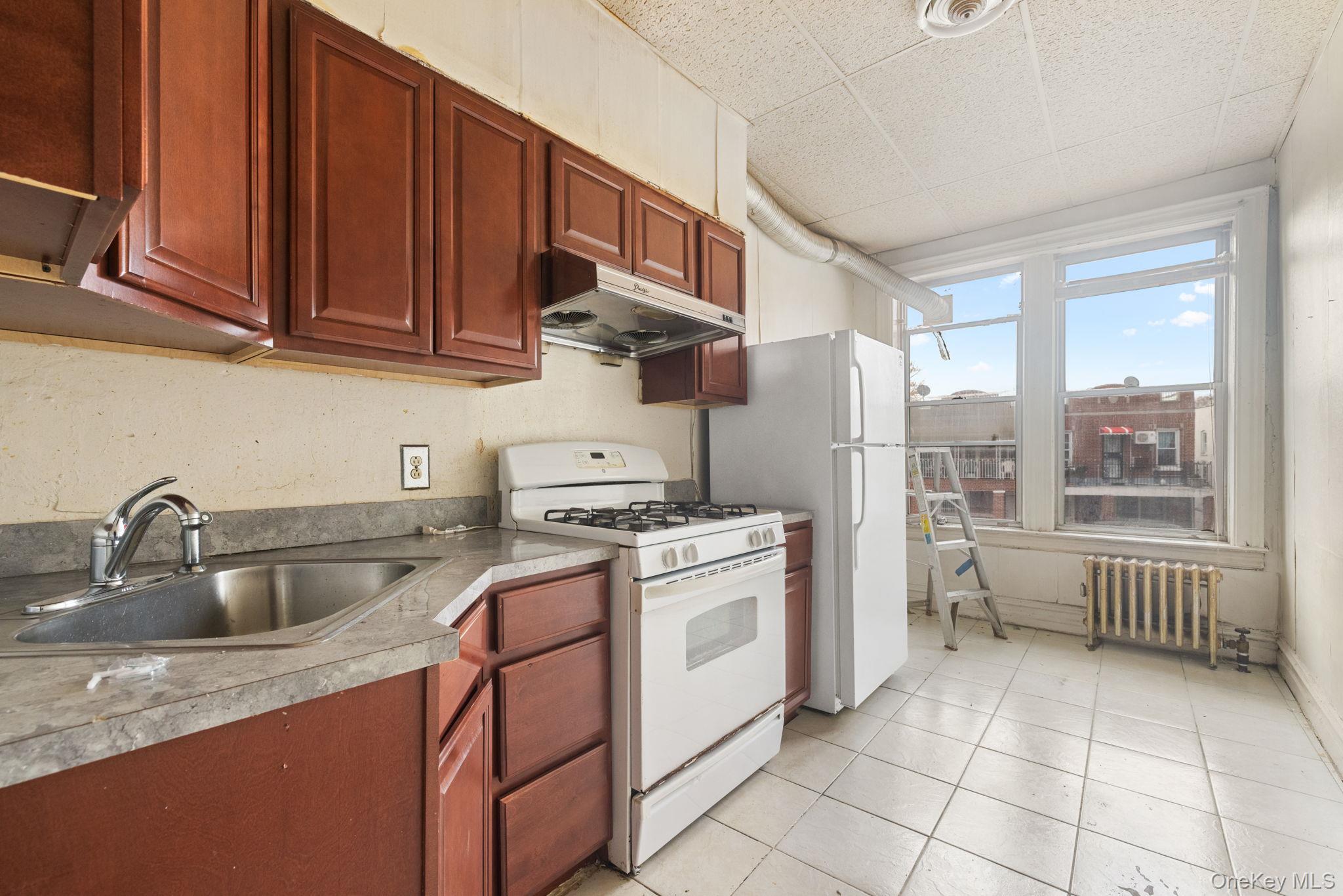 149 Dahill Road Brooklyn, NY 11218 - Photo 18 of 36 a kitchen with stainless steel appliances granite countertop a sink stove and cabinets