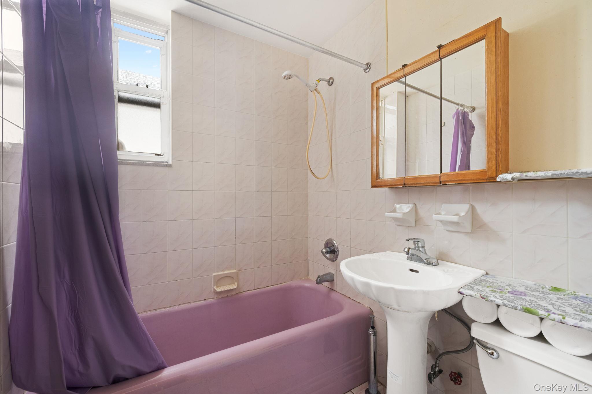 149 Dahill Road Brooklyn, NY 11218 - Photo 19 of 36 a bathroom with a sink and a bathtub