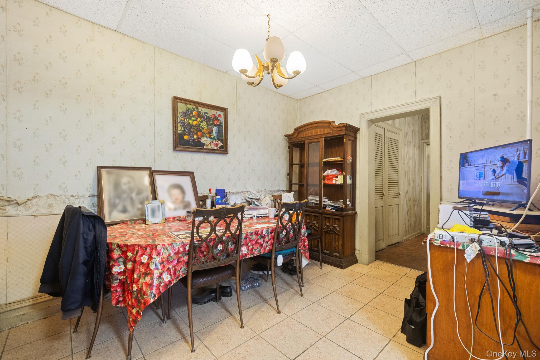 149 Dahill Road Brooklyn, NY 11218 - Photo 32 of 36 a bedroom with a bed and a chandelier