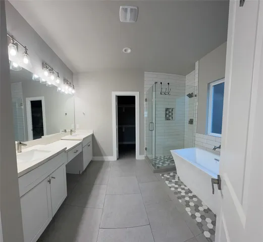 a spacious bathroom with a double vanity sink mirror and shower